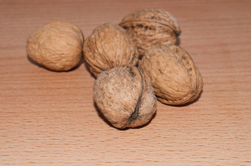 Walnuts on old rustic table in wooden bowl, Pile of Walnut kernels, Walnut background