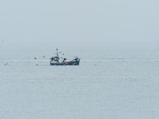 Obraz premium Fishing Boat on Misty Day