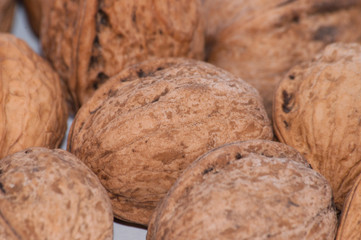 Pile of walnuts close-up macro, side view, copy space for text