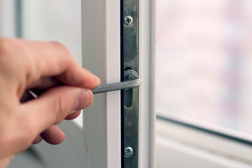 Workman adjusts the operation of the plastic window.