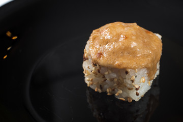 Japanese sushi rolls on a black plate. close view