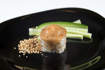 Japanese sushi rolls on a black plate. close view