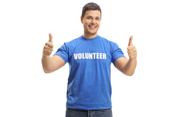 Fototapeta premium Young man volunteer in a blue t-shirt giving thumbs up