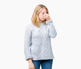 Beautiful young woman wearing winter sweater over isolated background tired rubbing nose and eyes feeling fatigue and headache. Stress and frustration concept.