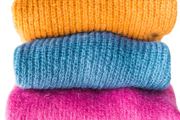 Pile of color woolen sweaters