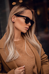 Beautiful blonde girl in retro sunglassses outdoor