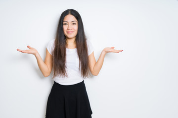 Beautiful brunette woman over isolated background clueless and confused expression with arms and hands raised. Doubt concept.