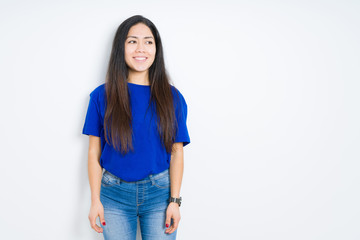 Fototapeta premium Beautiful brunette woman over isolated background looking away to side with smile on face, natural expression. Laughing confident.
