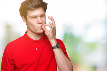 Young handsome man wearing red t-shirt over isolated background mouth and lips shut as zip with...