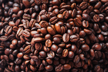 solid background of coffee beans roasted to chocolate color