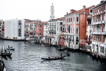 Venice / Italy 19 february 2019 :view of the Canal in Venice from Rialto bridge,gondolas are crossing the river and people enjoy their winter vacations