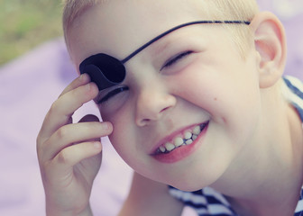 children's stylized birthday in nature outdoors in the style of pirates decor for kid. boys brothers in sea pirates costumes. candy bar decorations