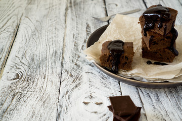 Chocolate Brownie on paper on white-brown rustic background with copy space