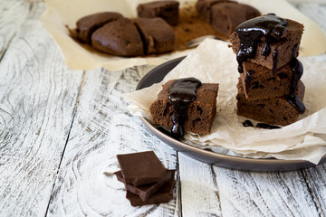 Chocolate Brownie on paper on white-brown rustic background with copy space