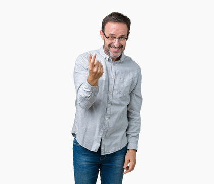Handsome middle age elegant senior man wearing glasses over isolated background Beckoning come here gesture with hand inviting happy and smiling