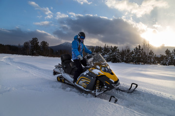 Athlete on a snowmobile.