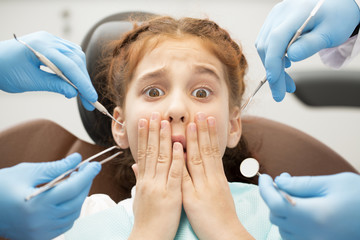Little scared girl at the dentist office