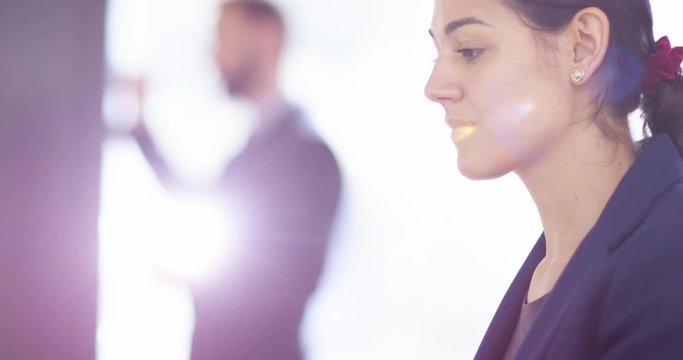 4K Closeup young smiling businesswoman typing on laptop in corporate office. Slow motion.
