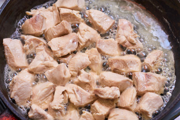 Slices of meat fried in a pan