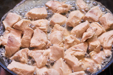 Slices of meat fried in a pan