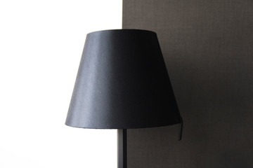 Black contemporary lamp shade on high contrast white and dark background