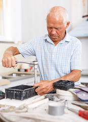 Senior man working on apartment overhauls