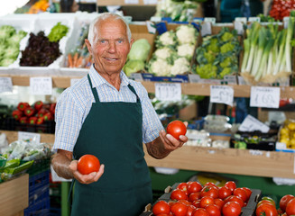 Salesman offering fresh fruits and vegetables