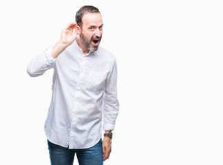 Fototapeta premium Middle age hoary senior man over isolated background smiling with hand over ear listening an hearing to rumor or gossip. Deafness concept.