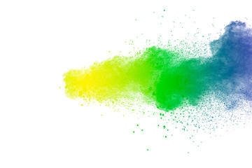 Colorful powder explosion on white background.Abstract blue yellow green  color dust particles...