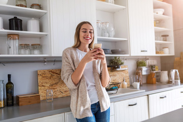 Young woman using her smartphone at home