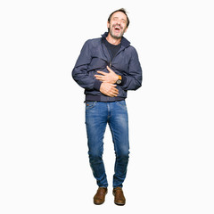Fototapeta premium Middle age handsome man wearing a jacket Smiling and laughing hard out loud because funny crazy joke. Happy expression.