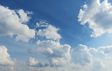 Blue sky with fluffy clouds, natural background 