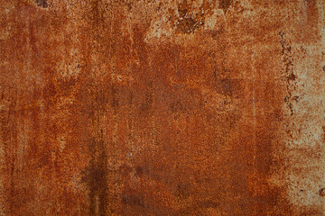 Rusty yellow-red textured metal surface. The texture of the metal sheet is prone to oxidation and corrosion. Textured Background in Grunge Style