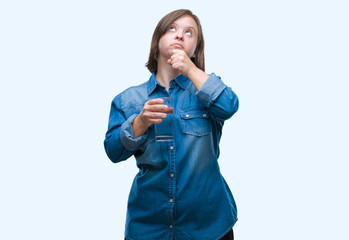 Young adult woman with down syndrome drinking water over isolated background serious face thinking about question, very confused idea