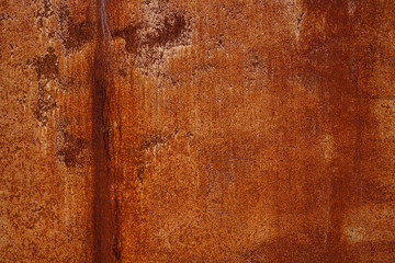 Rusty yellow-red textured metal surface. The texture of the metal sheet is prone to oxidation and corrosion. Textured background in grunge Style