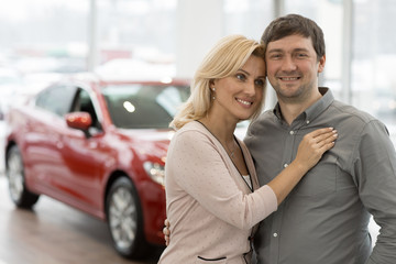 Happy mature couple buying a new car