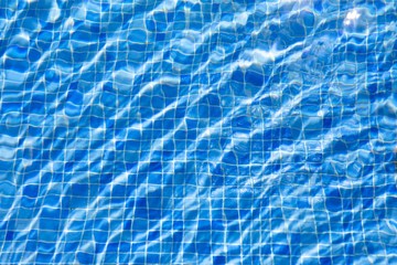 water ripples in swimming pool, blue background