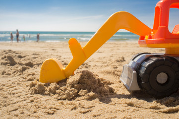Fototapeta na wymiar Excavator toy at the beach