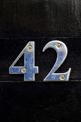 House number 42 seen close up with the the forty two in silver metal 