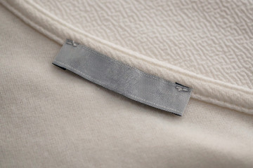 blank clothing label on white fabric texture background