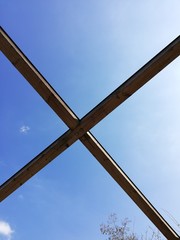 semicircular detail of wooden bridge and blue sky