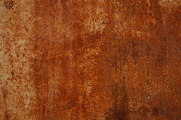 Rusty yellow-red textured metal surface. The texture of the metal sheet is prone to oxidation and corrosion. Textured background in grunge Style