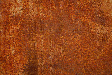 Rusty yellow-red textured metal surface. The texture of the metal sheet is prone to oxidation and corrosion. Textured Background in Grunge Style