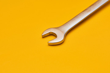 wrench isolated on yellow background