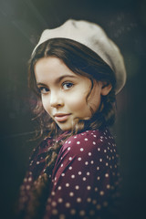 Urban female portrait. Beauty young girl turned around and looking at camera