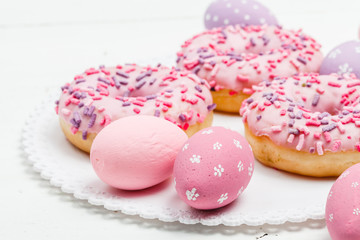 Yummy donuts with berries on the white wooden background. Sweet food. Close up