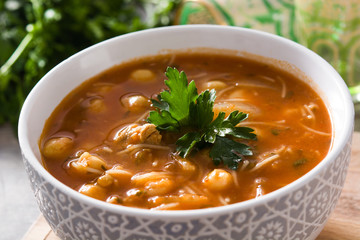 Harira soup in bowl on wooden table. Typical Moroccan food. Ramadán concept.Close up