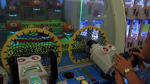 Teamwork of Mother and Daughter in Playing Arcade Game