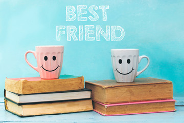 best friend concept with happy face cup coffee above books