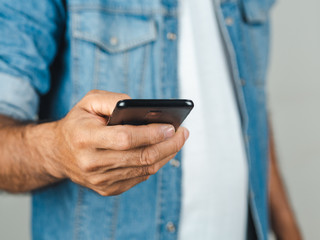 Closeup of young man using smartphone isolated on a white background